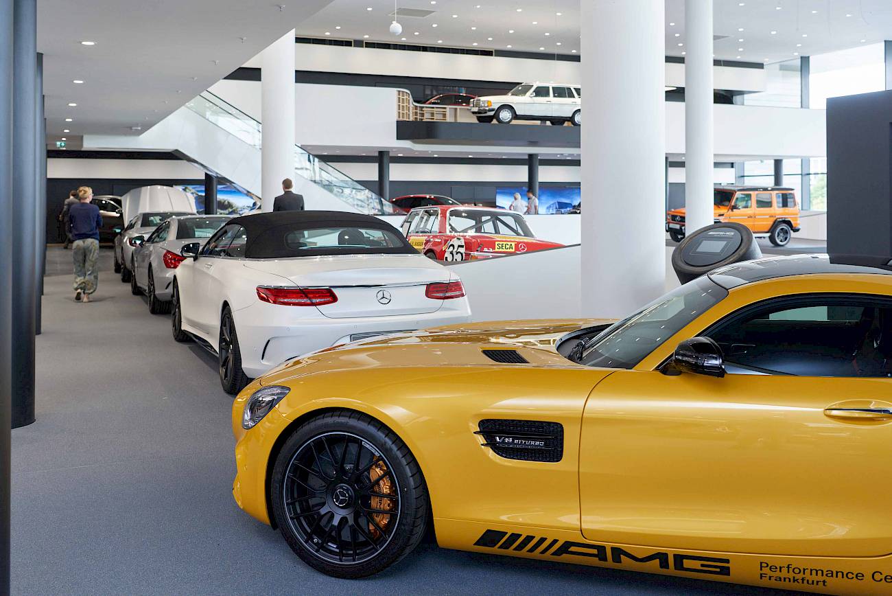 Cars on display inside a Mercedes-AMG showroom