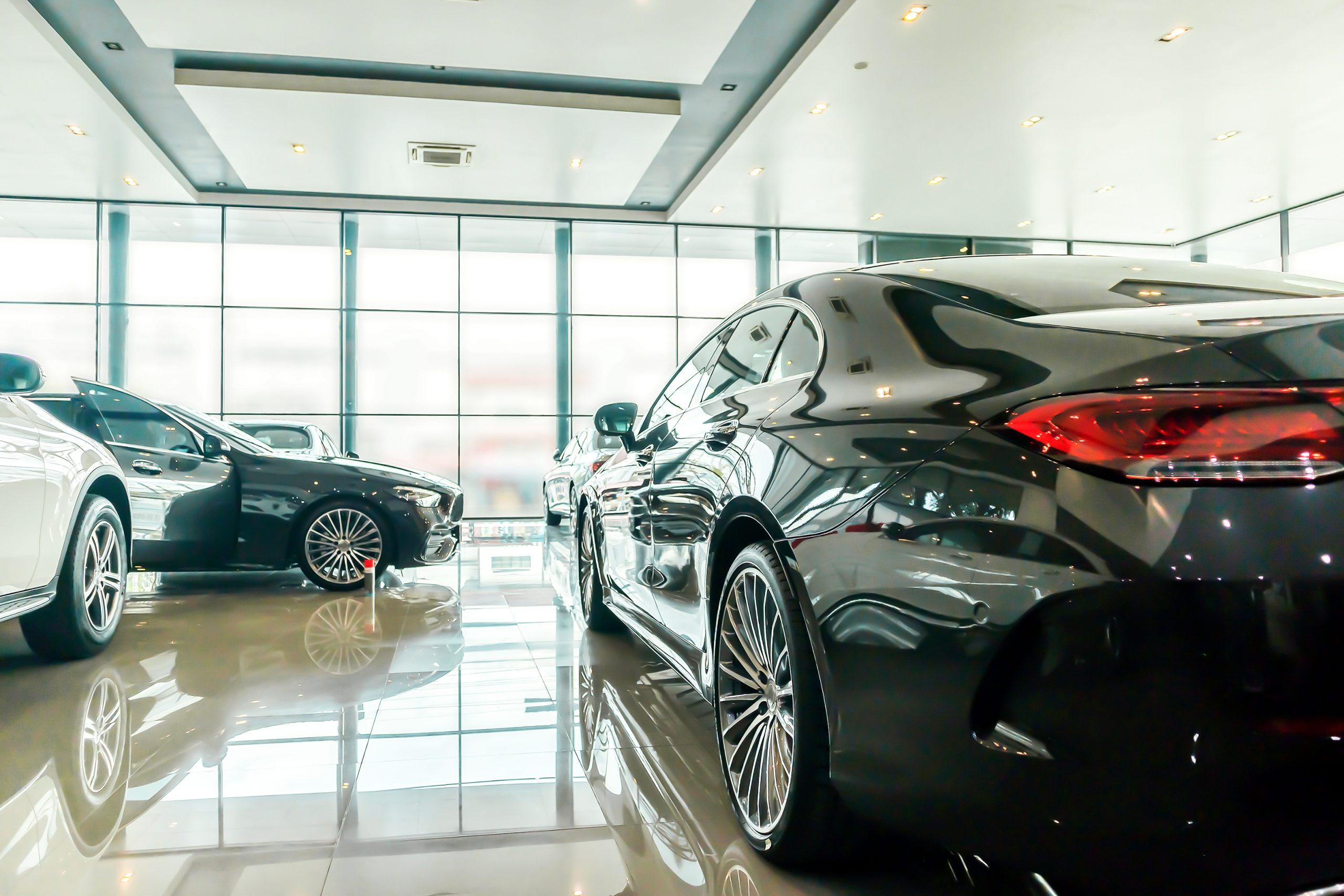 Cars inside a bright glass-fronted car showroom